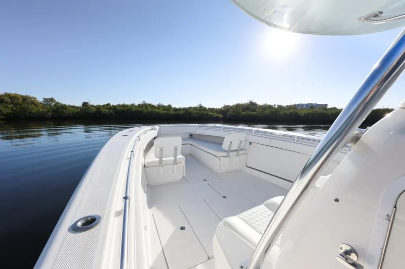 Slide: The Image of 2016 Invincible 39 Open Fisherman boat on calm water under clear sky. - 11