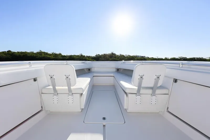 Slide: The Image of 2016 Invincible 39 Open Fisherman boat interior with seating, under clear blue sky. - 12