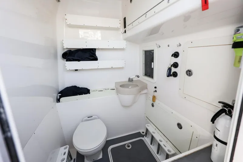 Slide: The Image of Interior of 2016 Invincible 39 Open Fisherman boat bathroom with toilet and sink. - 18