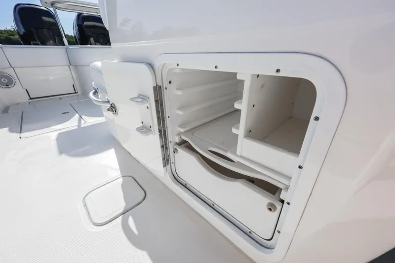 Slide: The Image of Open storage compartment on 2016 Invincible 39 Open Fisherman boat deck. - 20