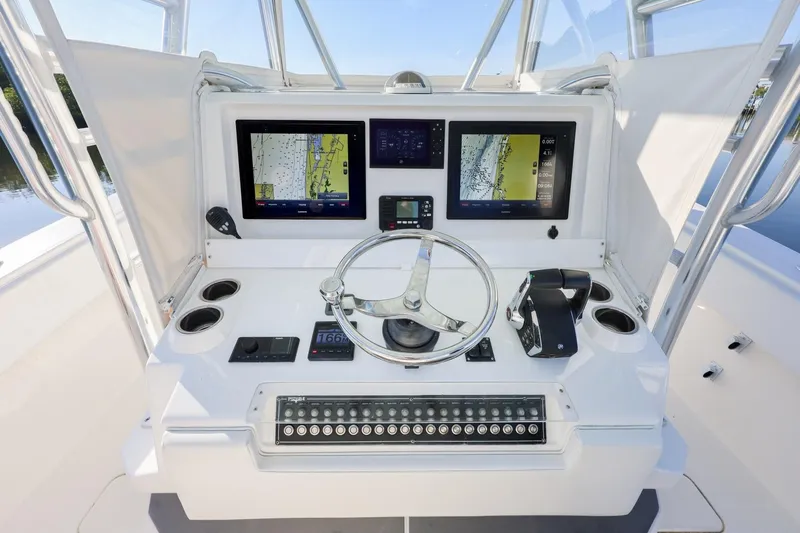 Slide: The Image of Control panel of 2016 Invincible 39 Open Fisherman boat with navigation screens and steering wheel. - 22