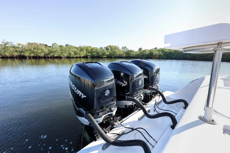 Slide: The Image of 2016 Invincible 39 Open Fisherman with triple Mercury outboard engines on calm water. - 25