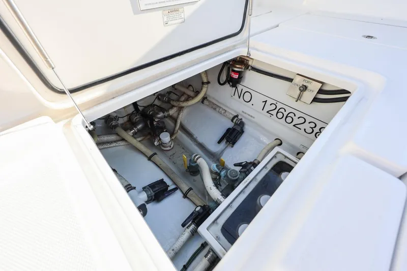 Slide: The Image of Open hatch of 2016 Invincible 39 Open Fisherman showing internal components and wiring. - 27