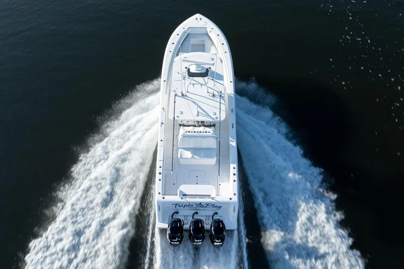 Slide: The Image of 2016 Invincible 39 Open Fisherman boat cruising on water, aerial view. - 35