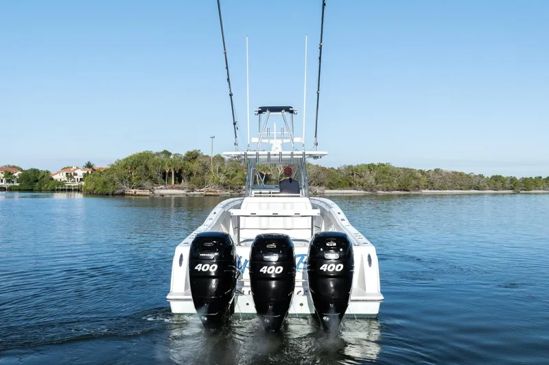 Slide: The Image of 2016 Invincible 39 Open Fisherman boat with triple 400 horsepower engines on calm water. - 6