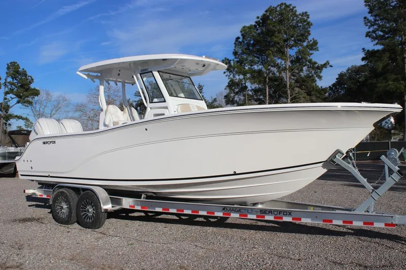 Slide: The Image of 2026 Sea Fox 288 Commander boat on trailer, parked outdoors. - 15