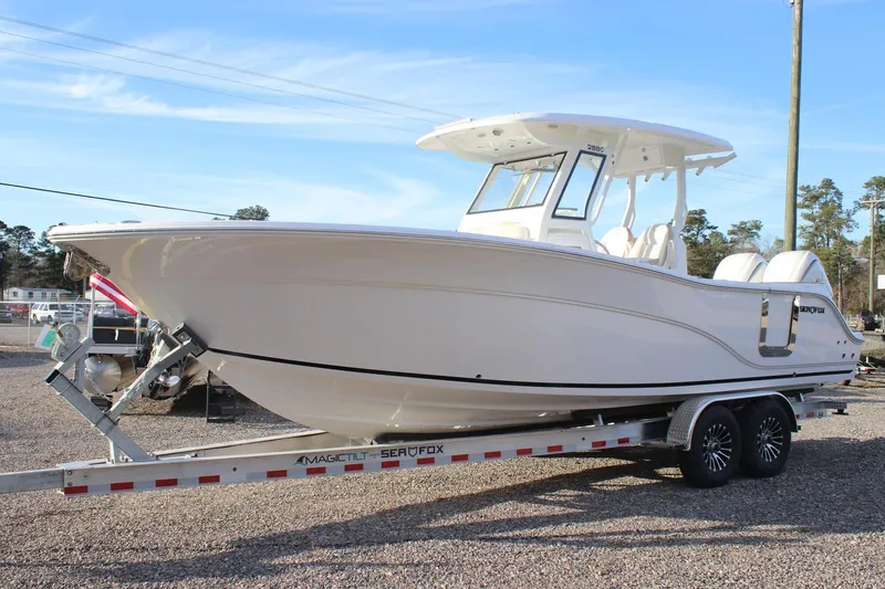 Slide: The Image of 2026 Sea Fox 288 Commander boat on trailer, parked outdoors under clear sky. - 16