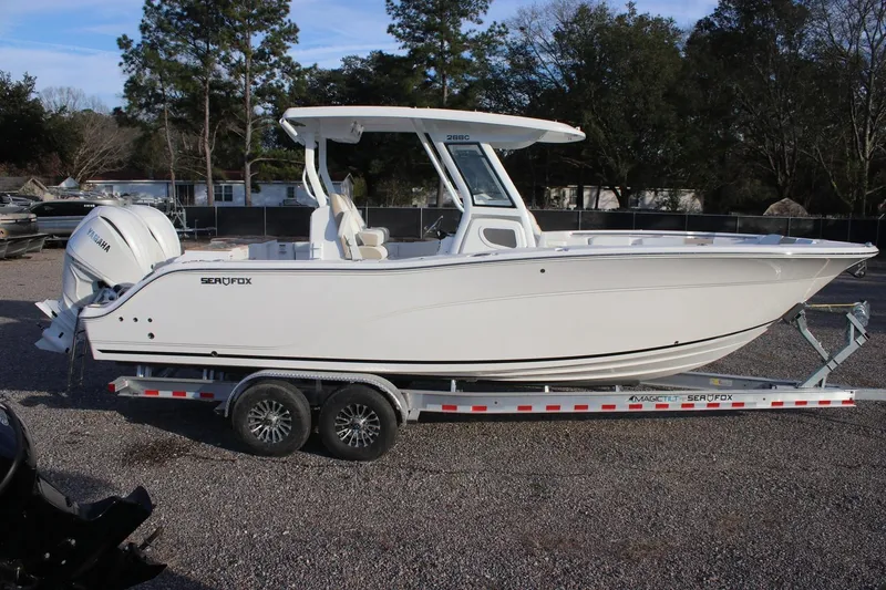 Slide: The Image of 2026 Sea Fox 288 Commander boat on trailer, side view, outdoors. - 18