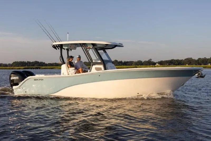 Slide: The Image of Manufacturer Provided Image: 2025 Sea Fox 288 Commander boat cruising on a calm lake. - 2