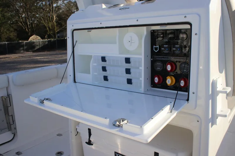 Slide: The Image of 2026 Sea Fox 288 Commander boat console with open storage and control panel. - 24