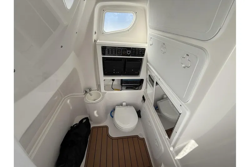 Slide: The Image of Interior of 2026 Sea Fox 288 Commander boat, featuring a compact marine bathroom. - 32