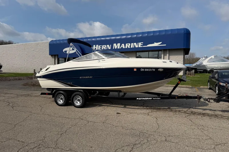 The Image of 2016 Stingray 215 LR boat on trailer outside Hern Marine dealership. - 1