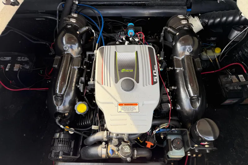 Slide: The Image of Engine compartment of a 2016 Stingray 215 LR boat, featuring a 5.0 MPI MerCruiser engine. - 14