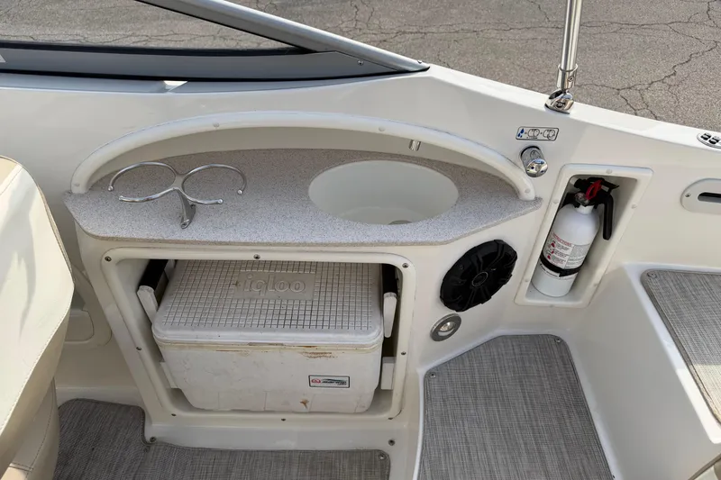 Slide: The Image of Interior of 2016 Stingray 215 LR boat with sink, cooler, and fire extinguisher. - 19