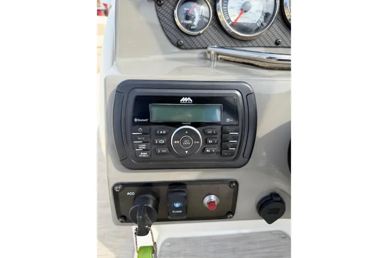 Slide: The Image of Dashboard of a 2016 Stingray 215 LR boat with audio controls and gauges. - 20