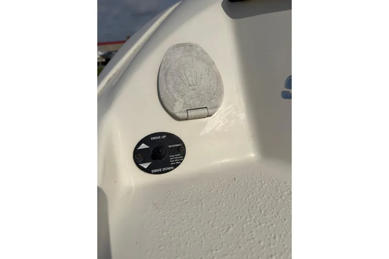 Slide: The Image of 2016 Stingray 215 LR boat control panel with drive adjustment switch. - 22
