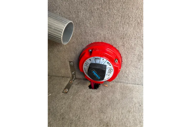 Slide: The Image of Red battery switch in a 2016 Stingray 215 LR boat interior. - 6
