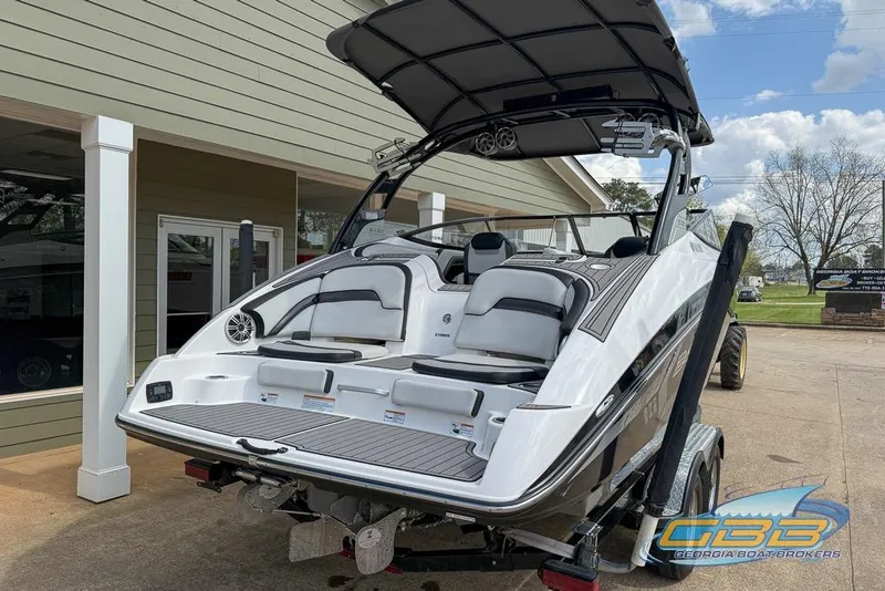 Slide: The Image of 2017 Yamaha Boats 242X E-Series on trailer, displayed outdoors at dealership. - 10