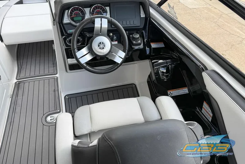 Slide: The Image of 2017 Yamaha Boats 242X E-Series cockpit with sleek steering wheel and modern dashboard controls. - 21