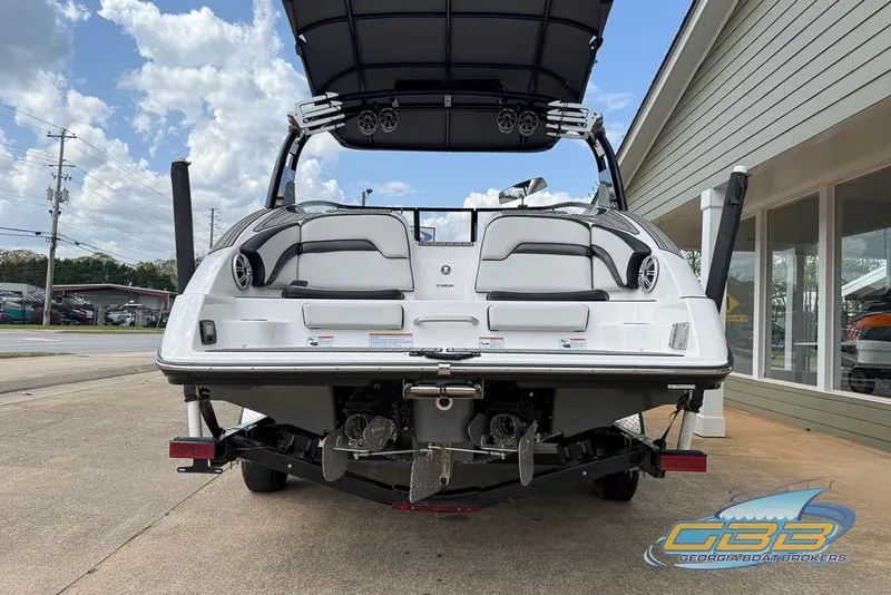 Slide: The Image of 2017 Yamaha Boats 242X E-Series, rear view, on trailer, with speakers and seating visible. - 7