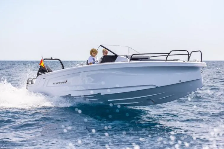 Slide: The Image of 2027 Axopar 25 Cross Bow boat cruising on open water, showcasing sleek design and performance. - 5