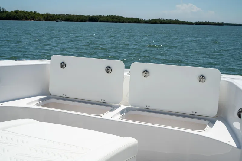 Slide: The Image of Twin Vee 280 GFX2 CC 2026, boat storage compartments by the water. - 18