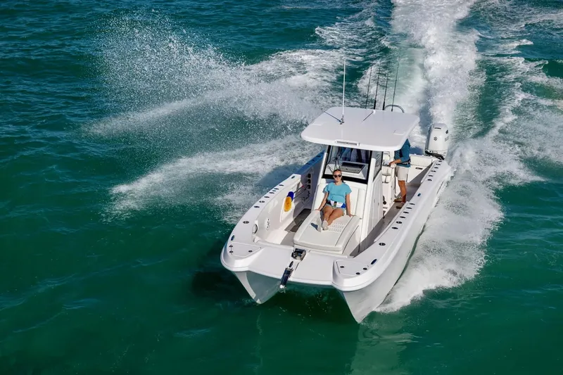 Slide: The Image of 2026 Twin Vee 280 GFX2 CC boat cruising on water. - 27