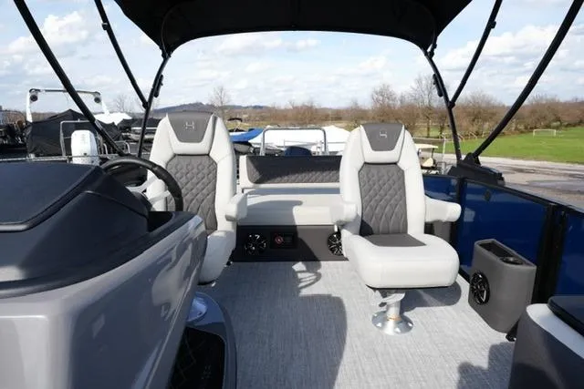 Slide: The Image of 2026 Harris Sunliner 230 boat interior with plush seating and modern design. - 10
