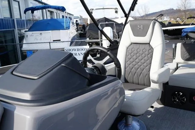 Slide: The Image of 2026 Harris Sunliner 230 boat interior with modern steering and luxurious seating. - 11