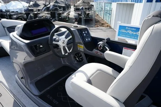 Slide: The Image of 2026 Harris Sunliner 230 boat cockpit with modern steering and controls. - 12