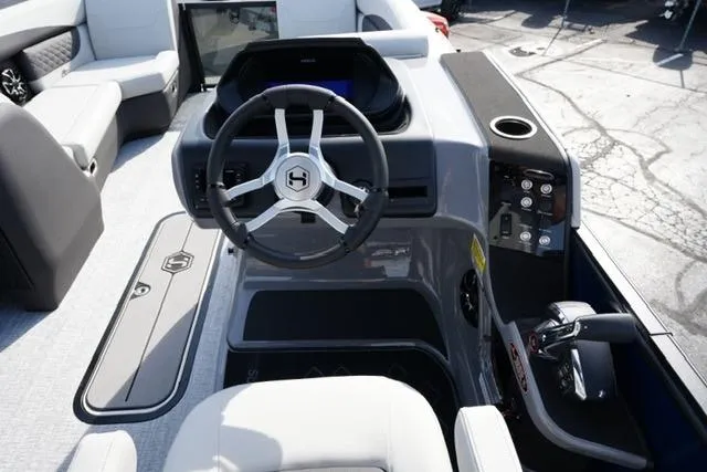 Slide: The Image of 2026 Harris Sunliner 230 boat interior with modern steering wheel and control panel. - 13