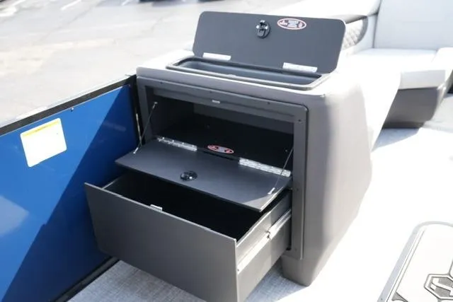 Slide: The Image of Open storage compartment on 2026 Harris Sunliner 230 boat, showcasing ample space. - 16