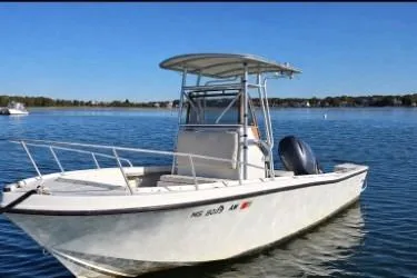 The Image of 1987 Mako 212 Center Console boat on calm water, featuring a sleek design and sturdy build. - 1