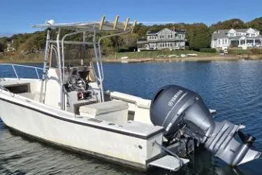Slide: The Image of 1987 Mako 212 Center Console boat with Yamaha outboard motor on a calm lake. - 2