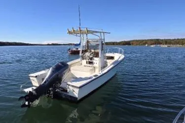 Slide: The Image of 1987 Mako 212 Center Console boat on calm lake waters. - 3
