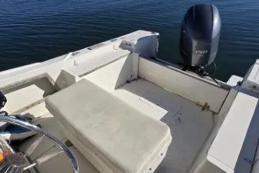 Slide: The Image of 1987 Mako 212 Center Console boat with outboard motor on calm water. - 6