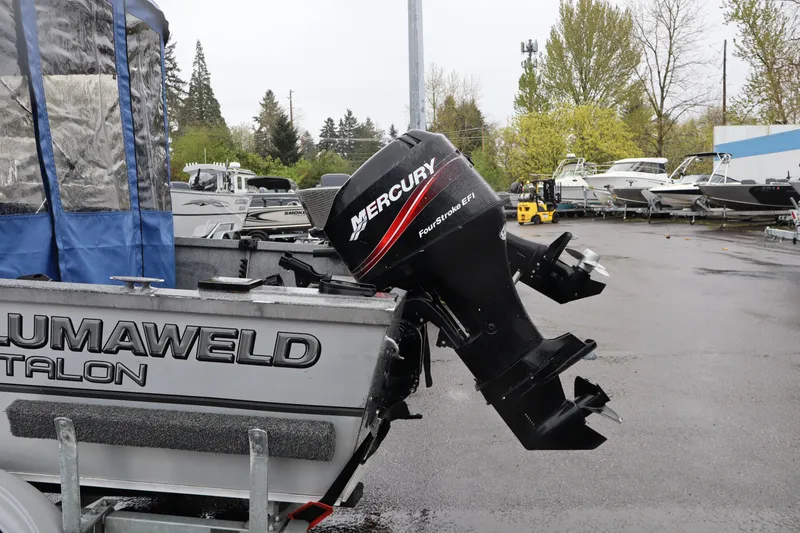 Slide: The Image of 2005 Alumaweld Talon 17 boat with Mercury FourStroke EFI outboard motor in a marina setting. - 5