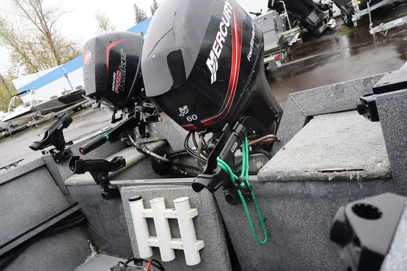 Slide: The Image of 2005 Alumaweld Talon 17 boat with Mercury outboard motors in a wet dock setting. - 7