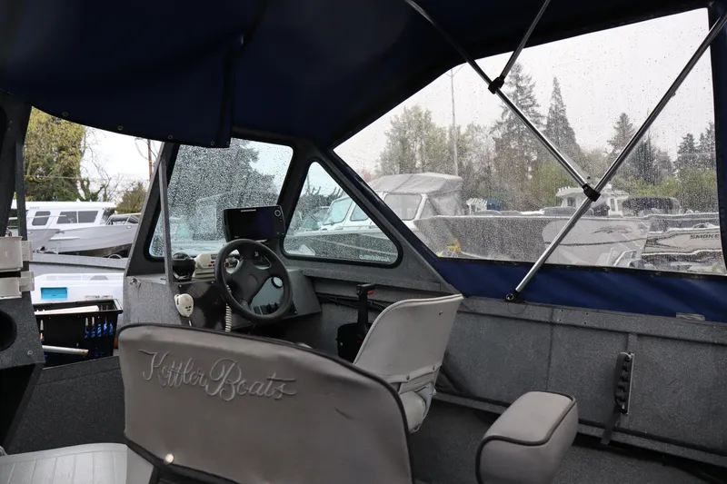 Slide: The Image of Interior of a 2005 Alumaweld Talon 17 boat with steering wheel and seating. - 8