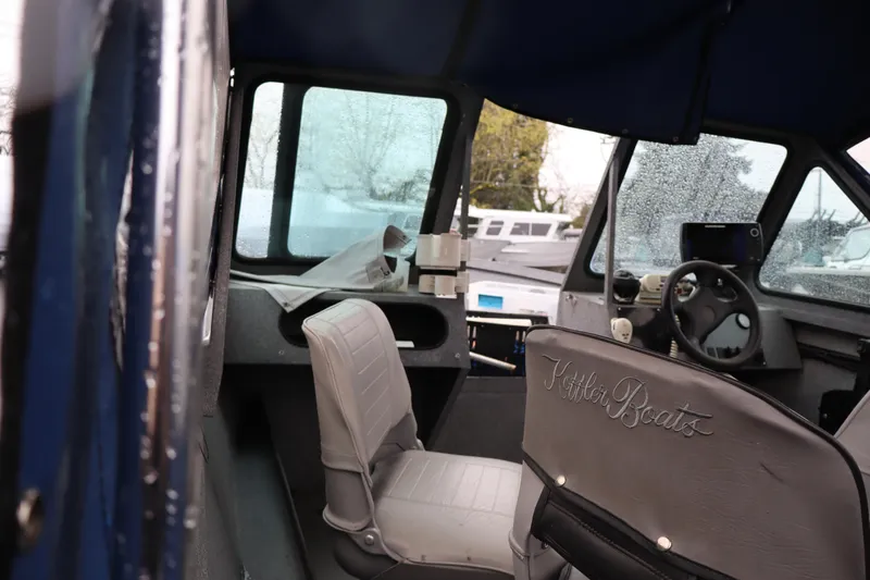 Slide: The Image of Interior of a 2005 Alumaweld Talon 17 boat with steering wheel and seating. - 9