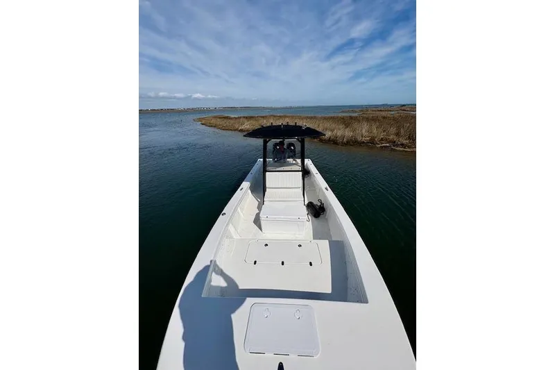 Slide: The Image of 2025 C-Hawk 26 Center Console boat on calm water under blue sky. - 12