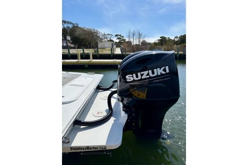 Slide: The Image of 2025 C-Hawk 26 Center Console with Suzuki outboard motor on water. - 6