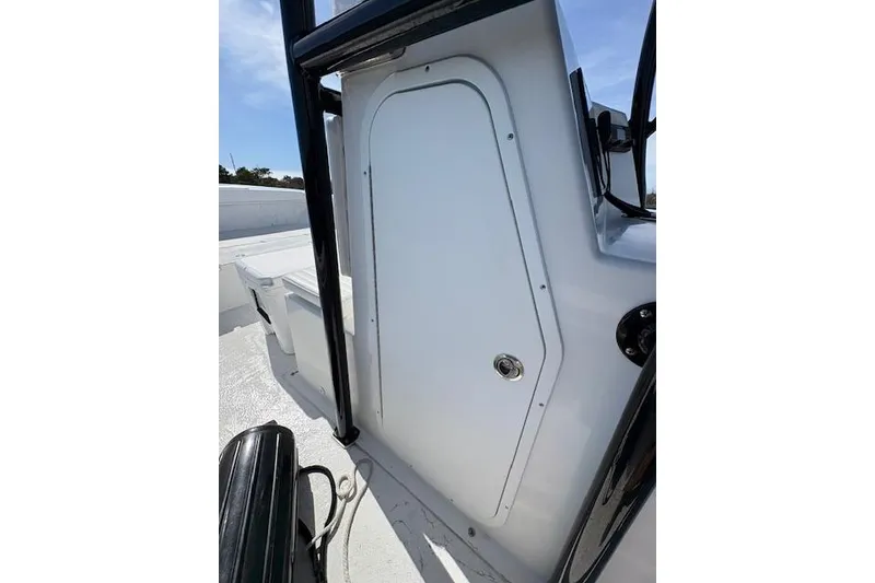 Slide: The Image of 2025 C-Hawk 26 Center Console boat interior, featuring a sleek white panel and storage compartment. - 8
