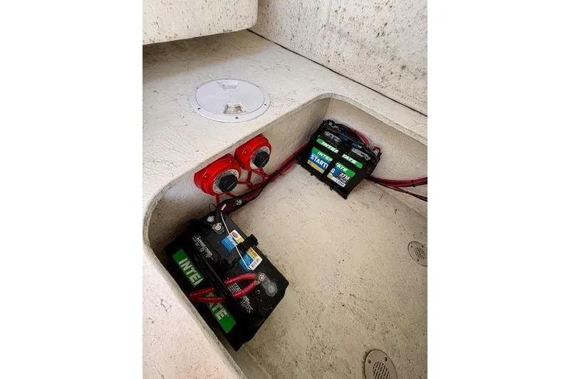 Slide: The Image of Battery compartment of 2025 C-Hawk 26 Center Console boat with wiring and switches. - 9