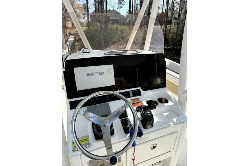 Slide: The Image of 2018 Sea Hunt Ultra 234 boat dashboard with steering wheel and navigation system. - 8