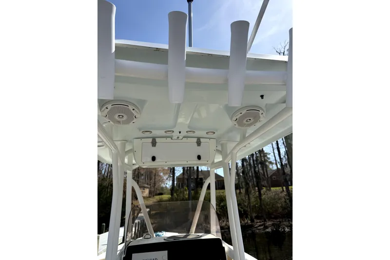 Slide: The Image of 2018 Sea Hunt Ultra 234 boat interior with rod holders and speakers. - 9