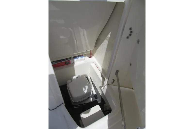 Slide: The Image of 2023 Robalo R180 Center Console interior with compact marine toilet. - 12