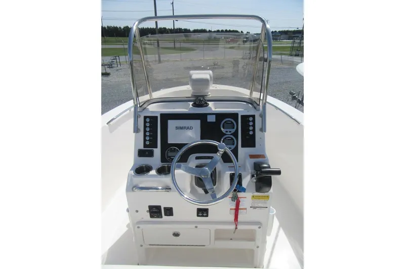 Slide: The Image of 2023 Robalo R180 Center Console boat dashboard with steering wheel and navigation controls. - 13
