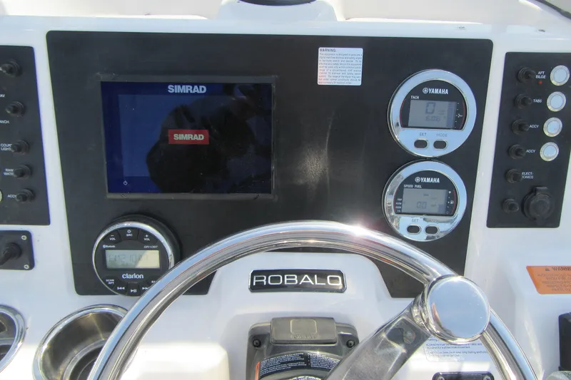 Slide: The Image of 2023 Robalo R180 Center Console dashboard with Simrad display and Yamaha gauges. - 14