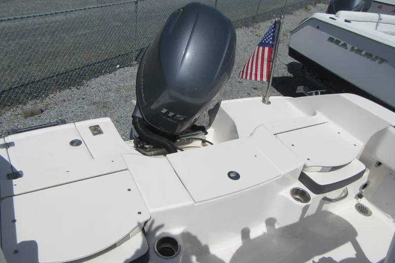 Slide: The Image of 2023 Robalo R180 Center Console boat with Yamaha 115 engine and American flag. - 16